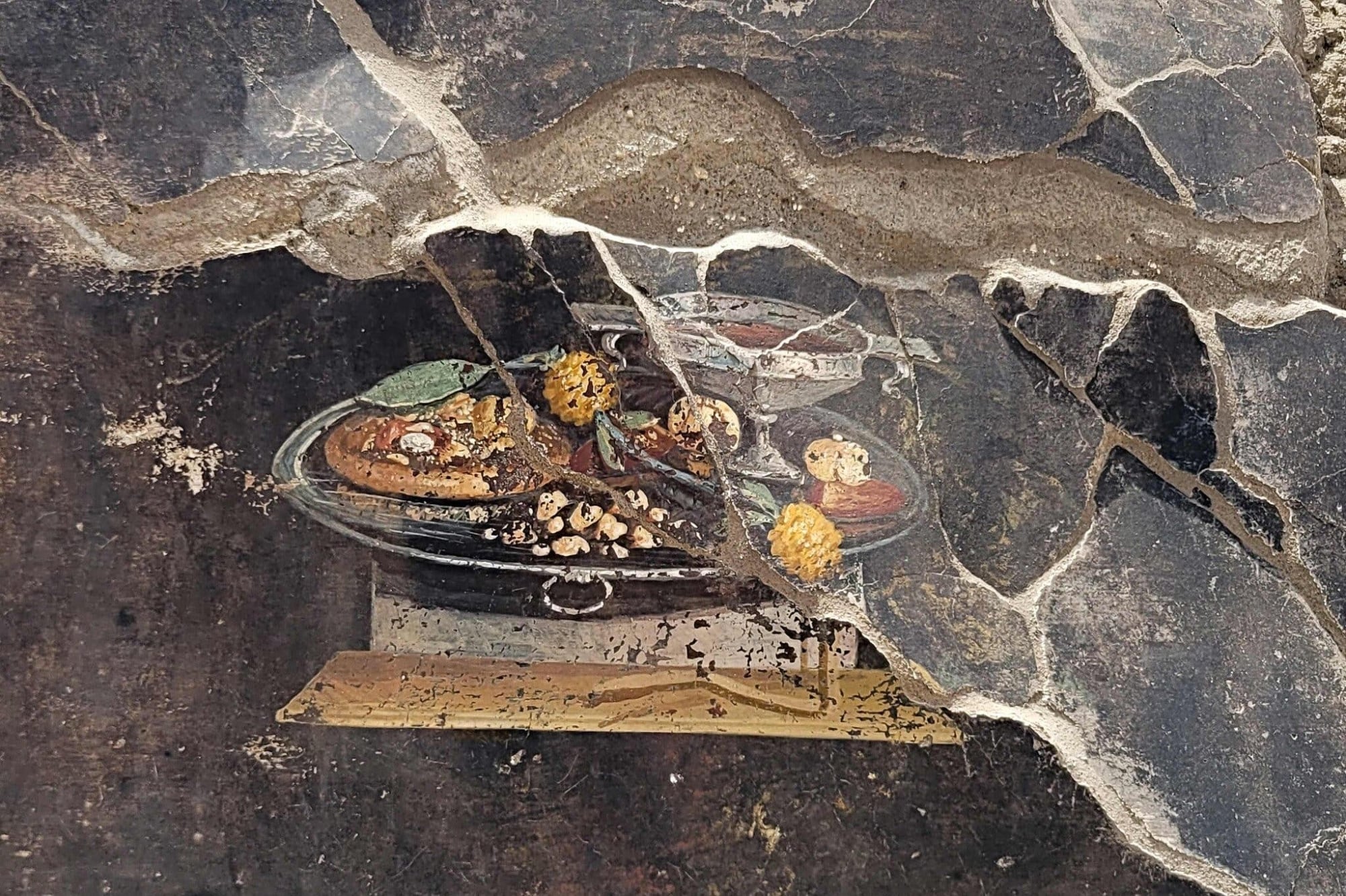 Archaeologists Uncover a Fresco in Pompeii with a Cheesy Pizza-Like Dish Served on a Silver Platter